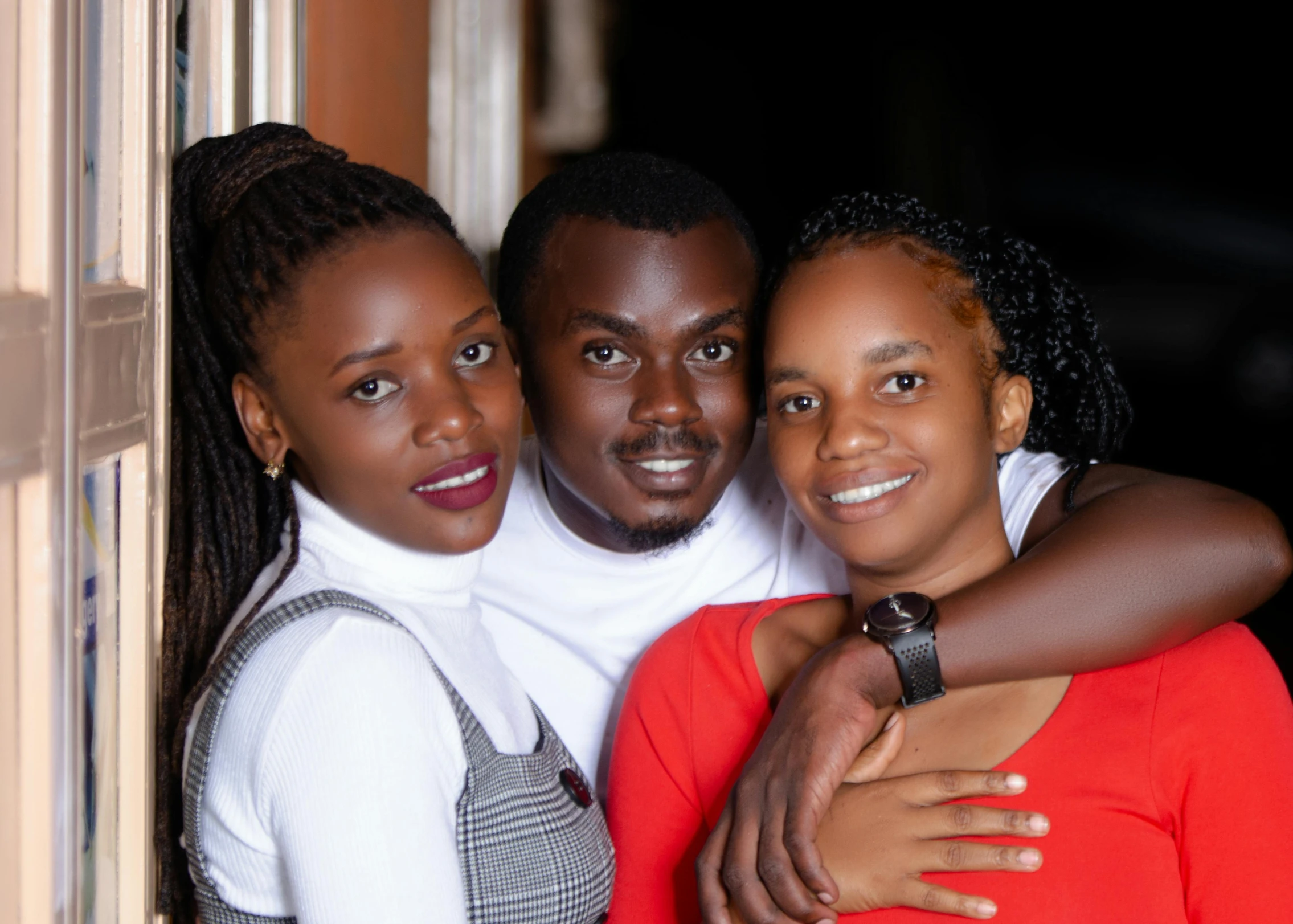 a man and two women are smiling for the camera