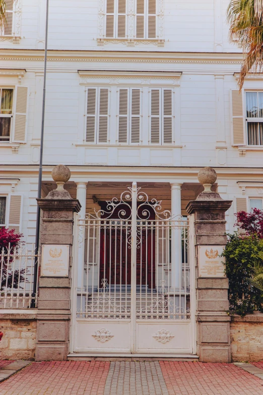 an open gate stands in front of a two story building