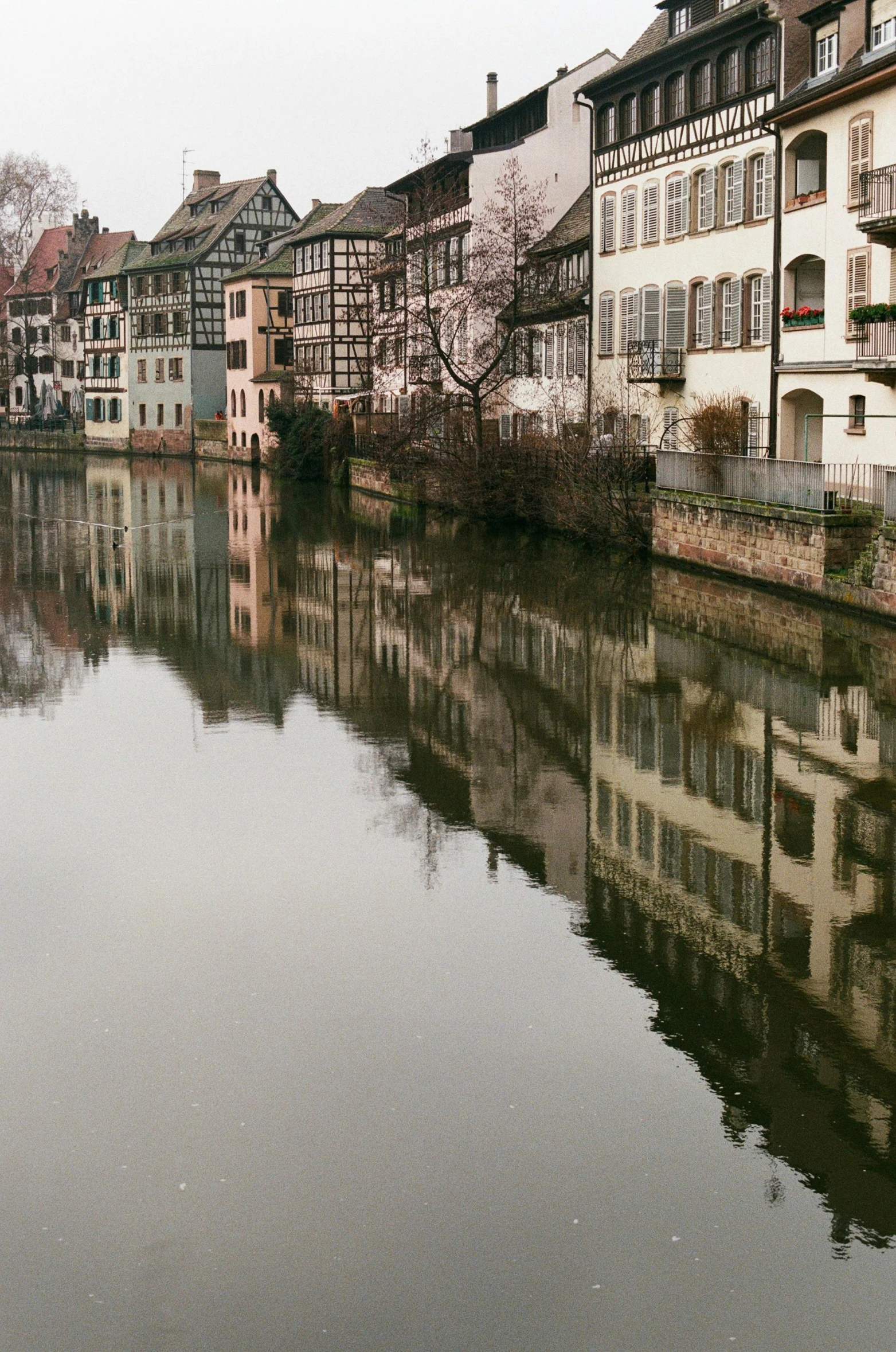 some buildings in the background and water reflecting them