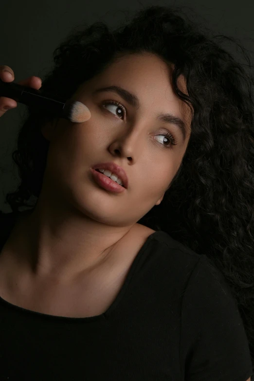 a woman with a neutral light makeup looks at the camera