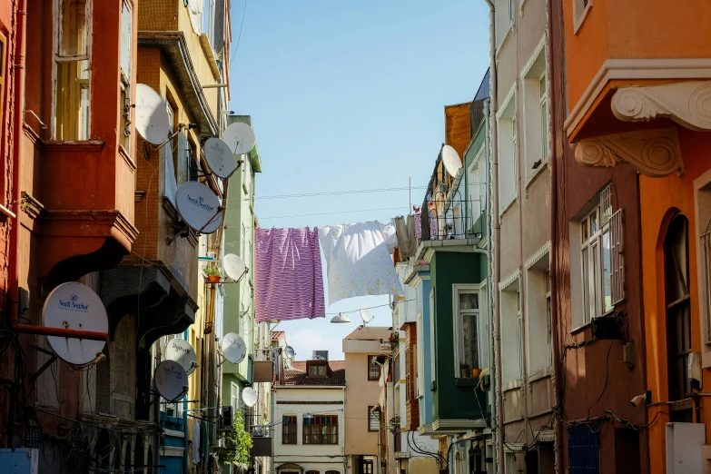 a narrow street with laundry lines on either side