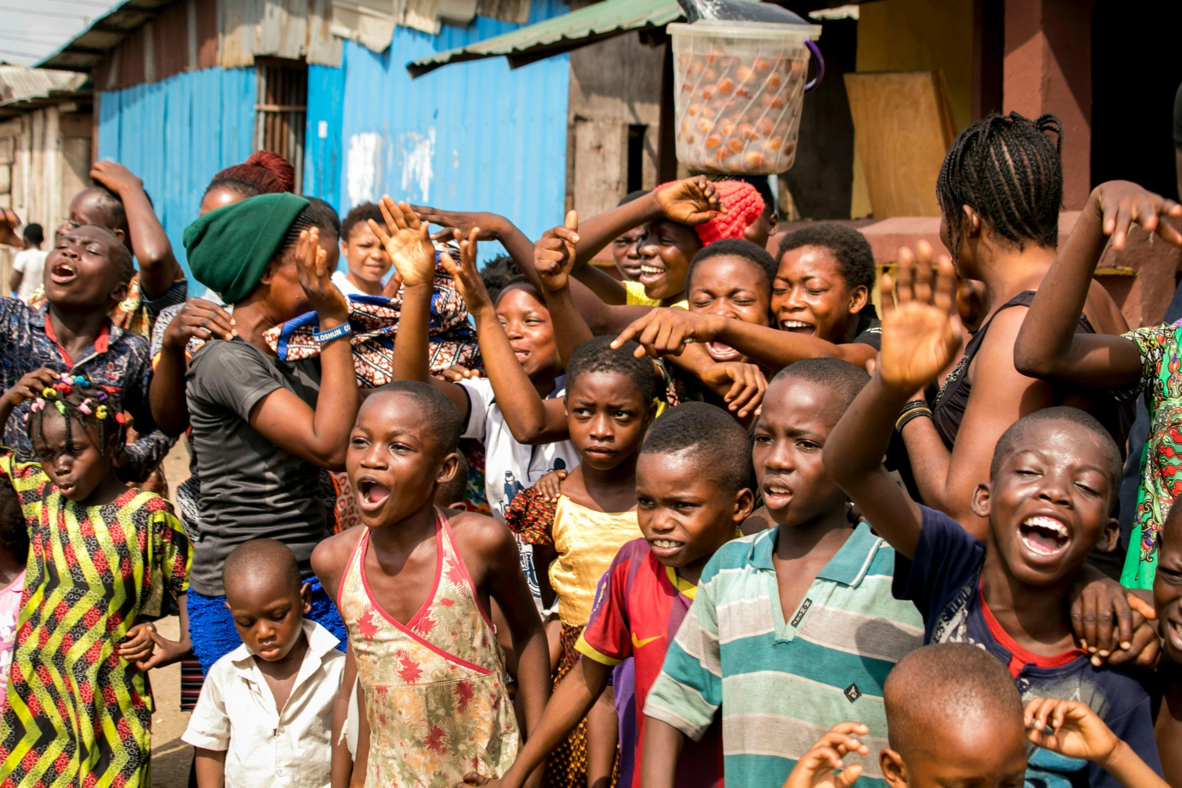 a group of young people waving with the help of people