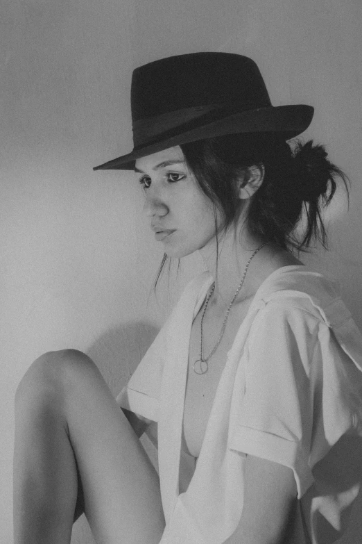 a beautiful young woman in black and white wearing a hat