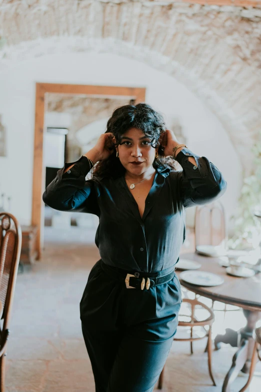 a woman is posing for a po in front of the table