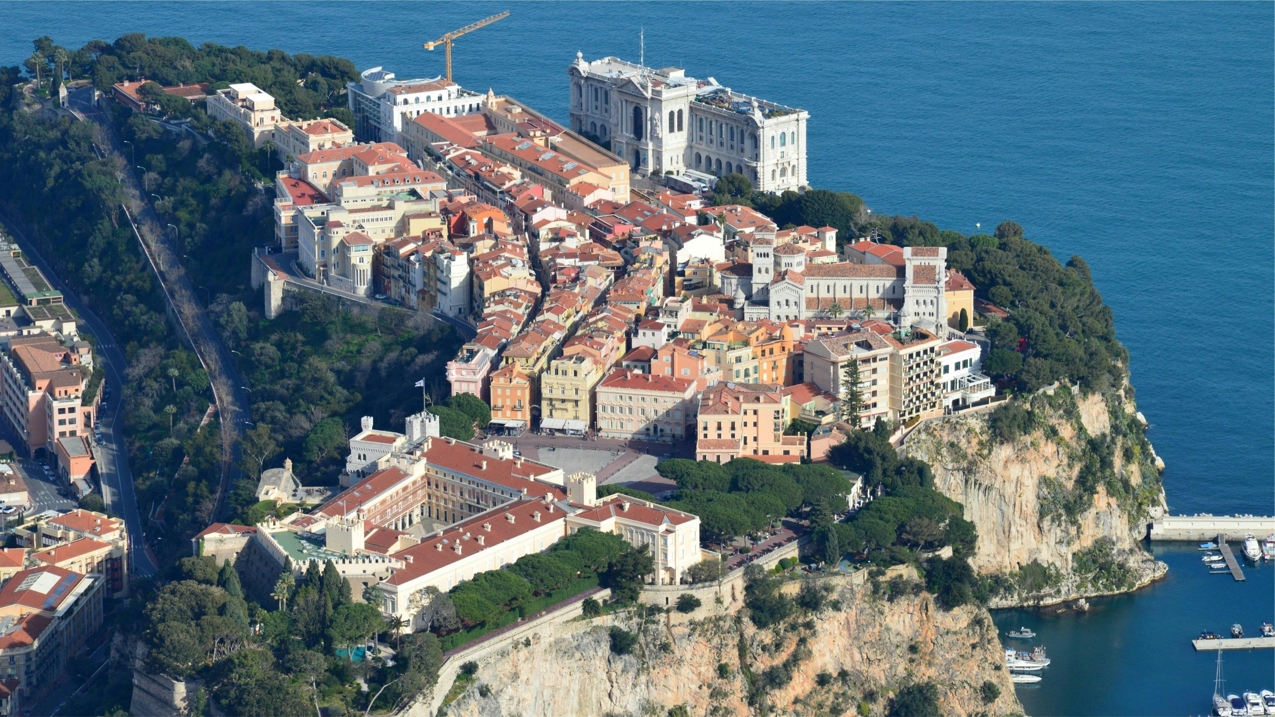 an aerial view of a city next to water