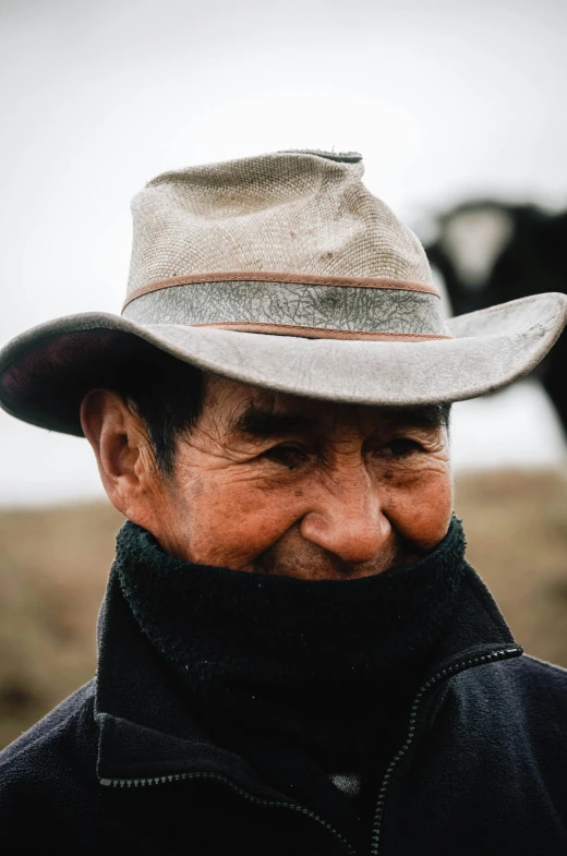 an older man is standing in front of a cow