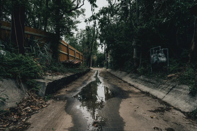 a road with lots of water flowing on the side of it