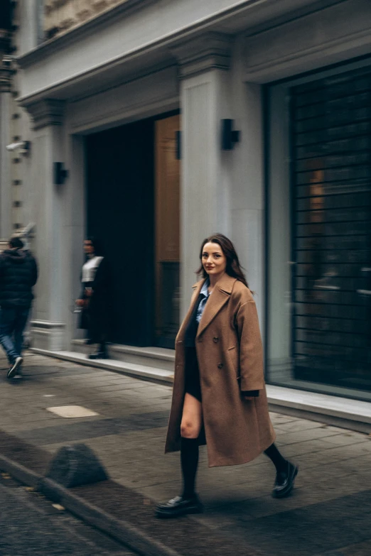 a woman walking down the street and looking ahead