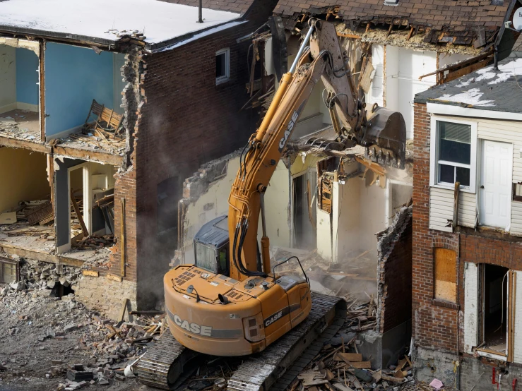 a yellow bulldozer is near some demolished buildings