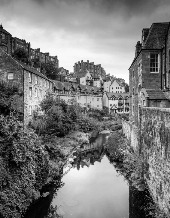 black and white po of old buildings by a river