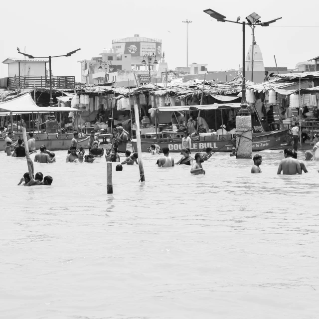 several people are swimming in water near a street