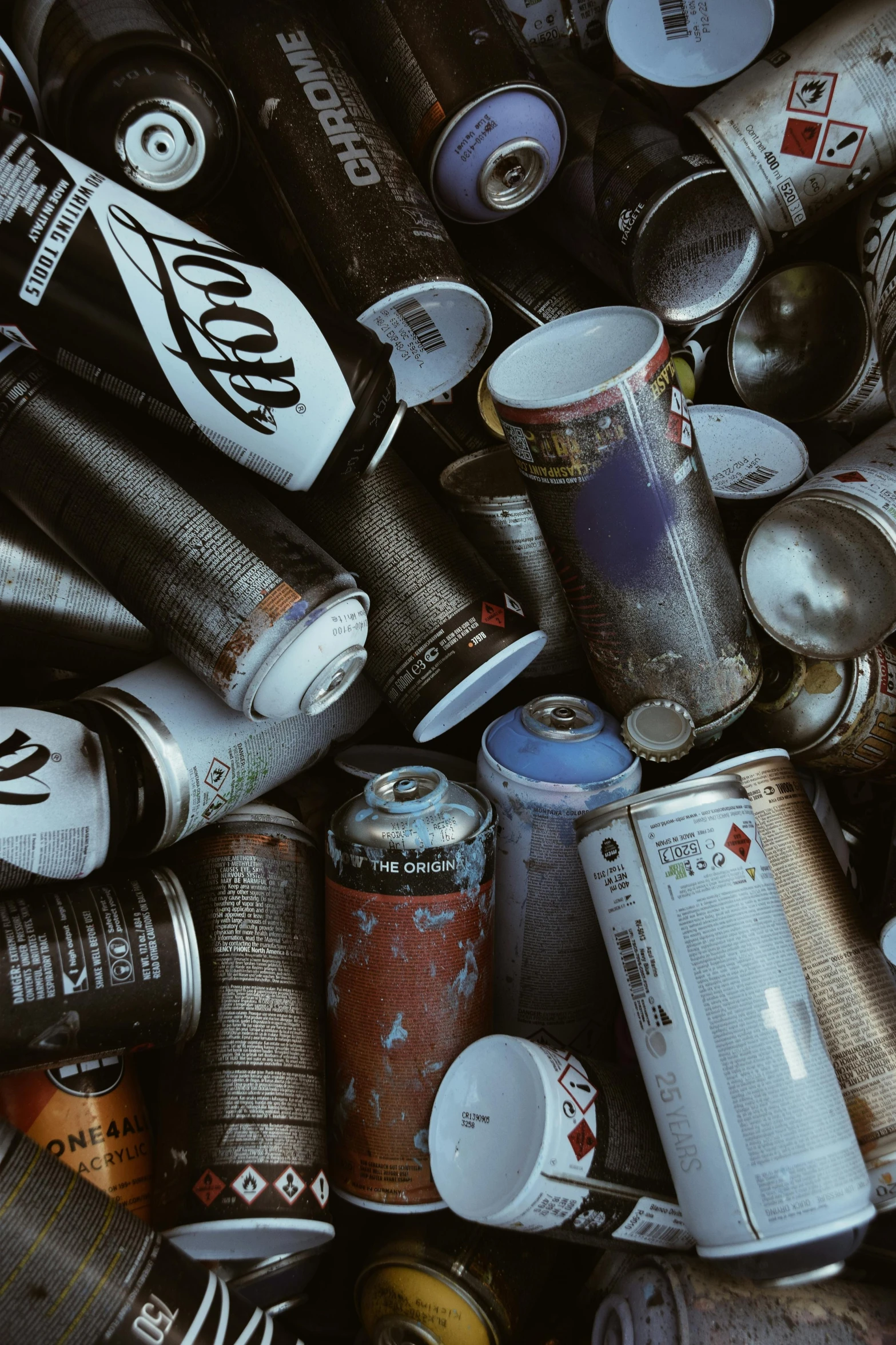 a bunch of empty soda cans and tins