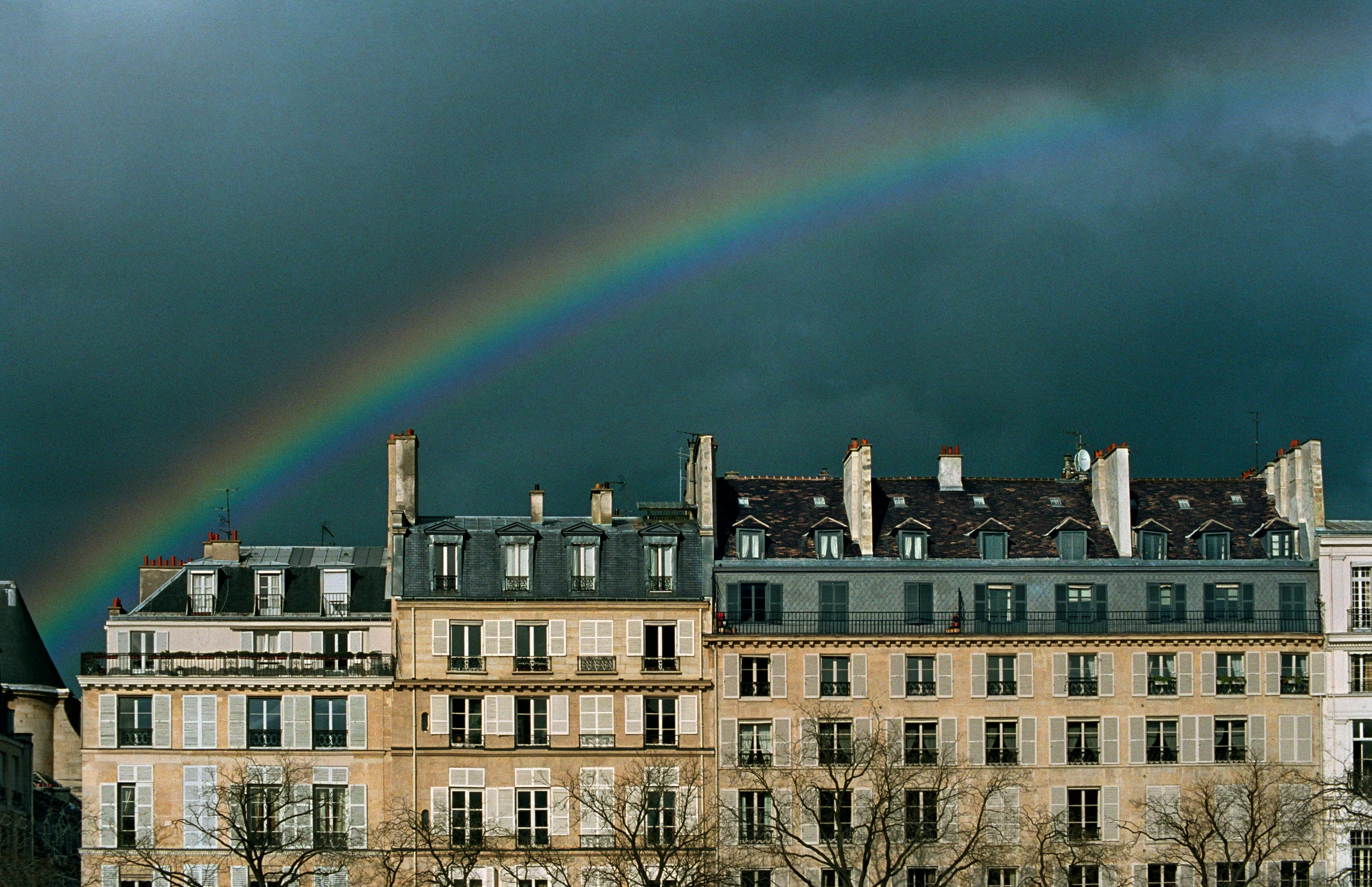 a building with a rainbow that is on the other side of the image