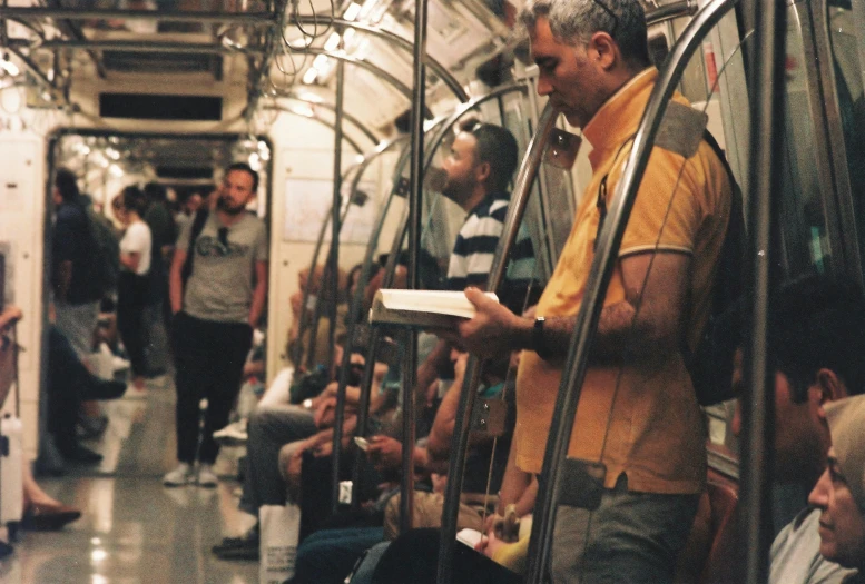 people riding on a train while holding luggage