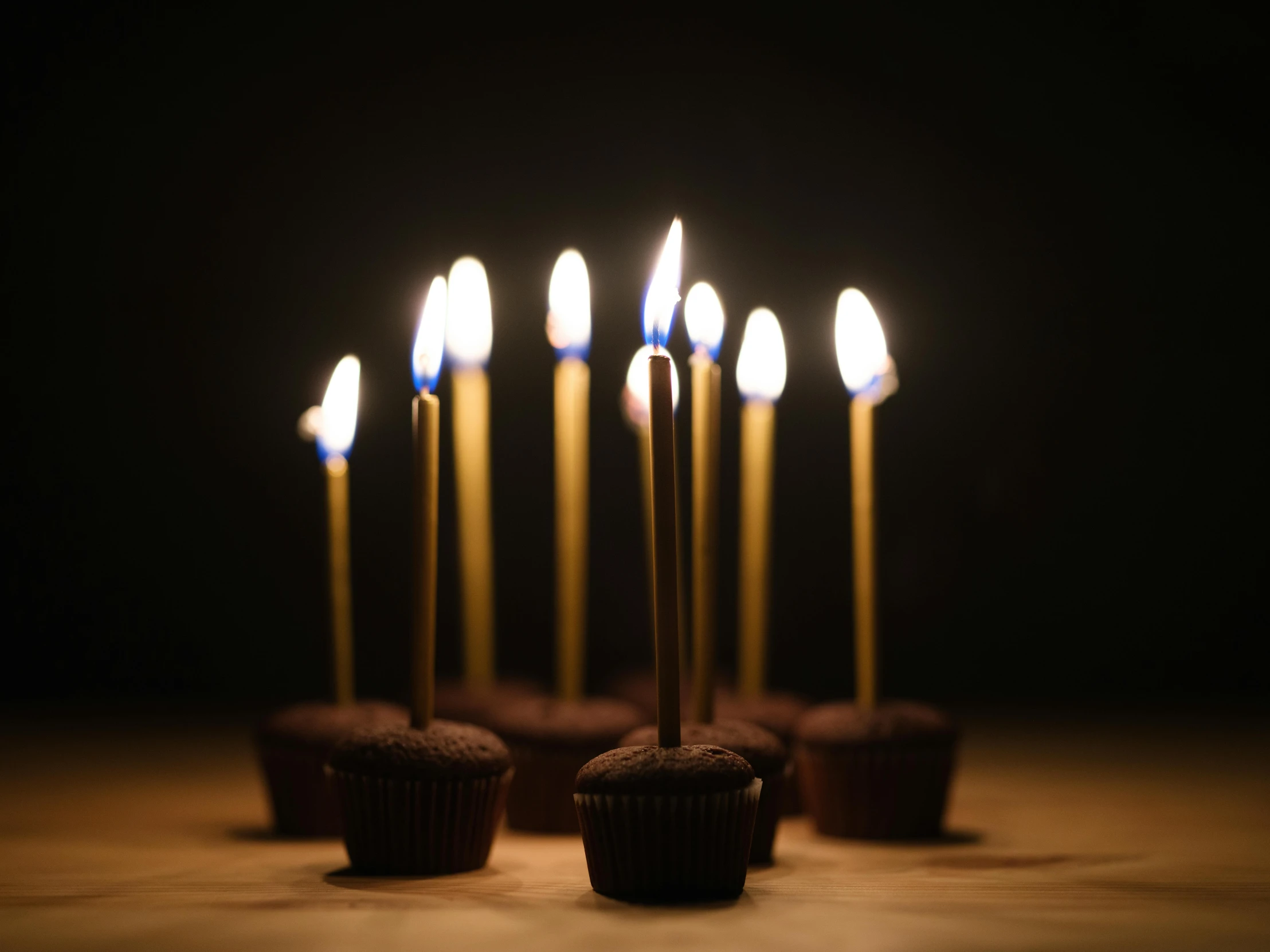 a small cupcake with five candles in it