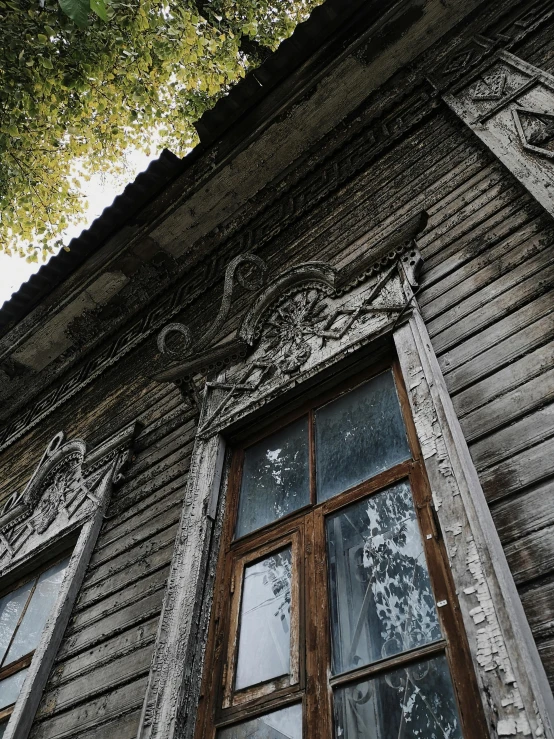 a close up view of the windows and wooden siding on an old building