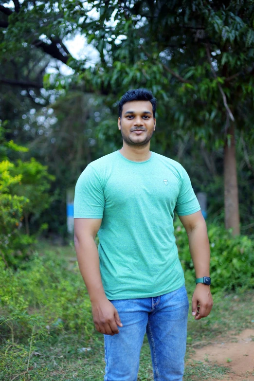 a man standing in front of some trees