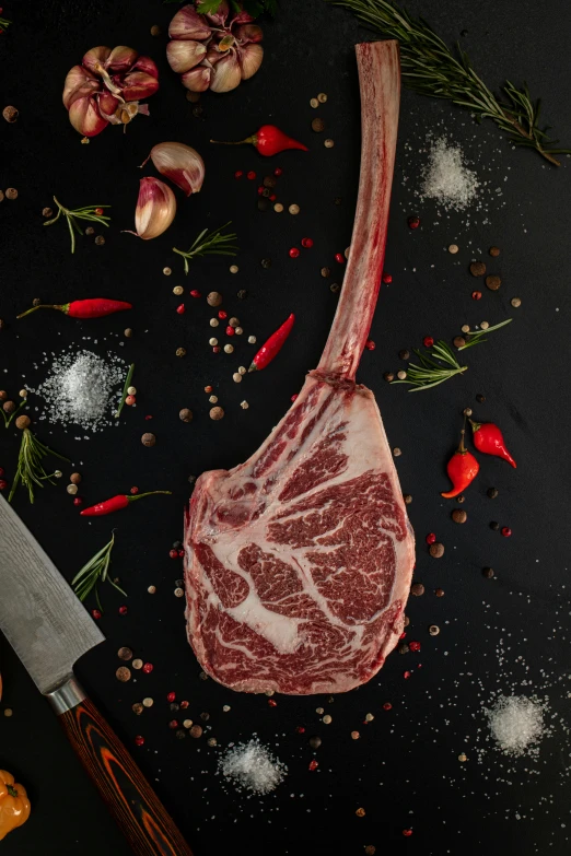 raw ribs fillet with herbs and spices on a black background