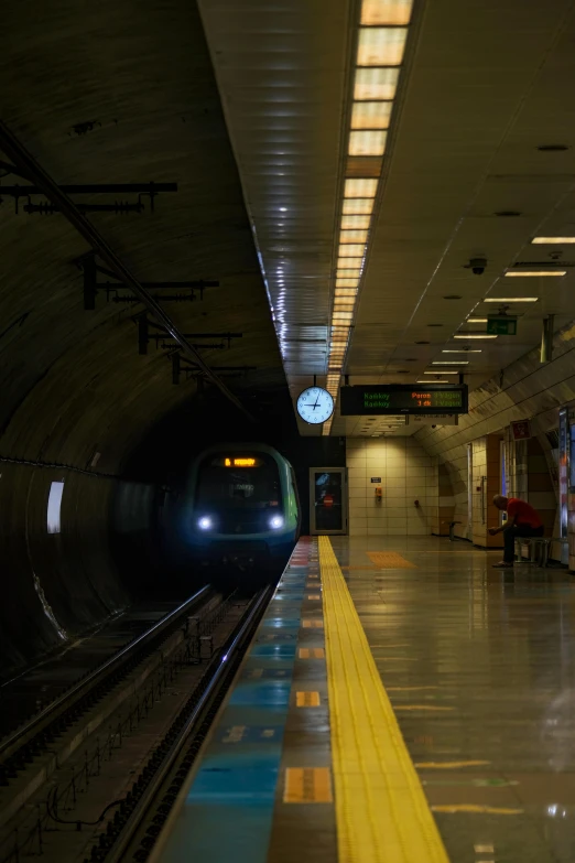 the subway train is in a dark lit station