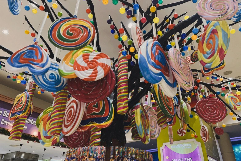 an elaborate display of candy candies hanging from a ceiling