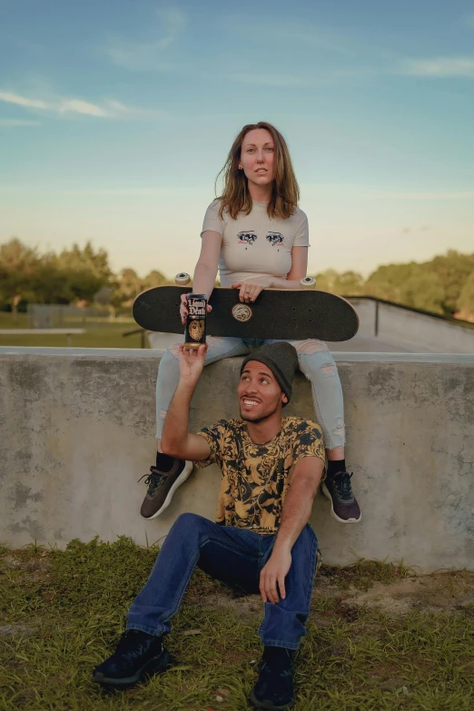 a girl sitting on a boy on the ground