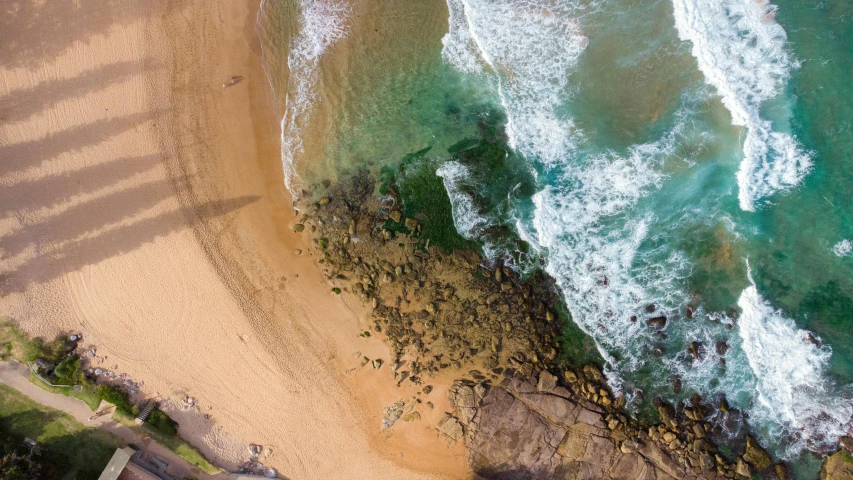 the ocean and the beach is shown from the air