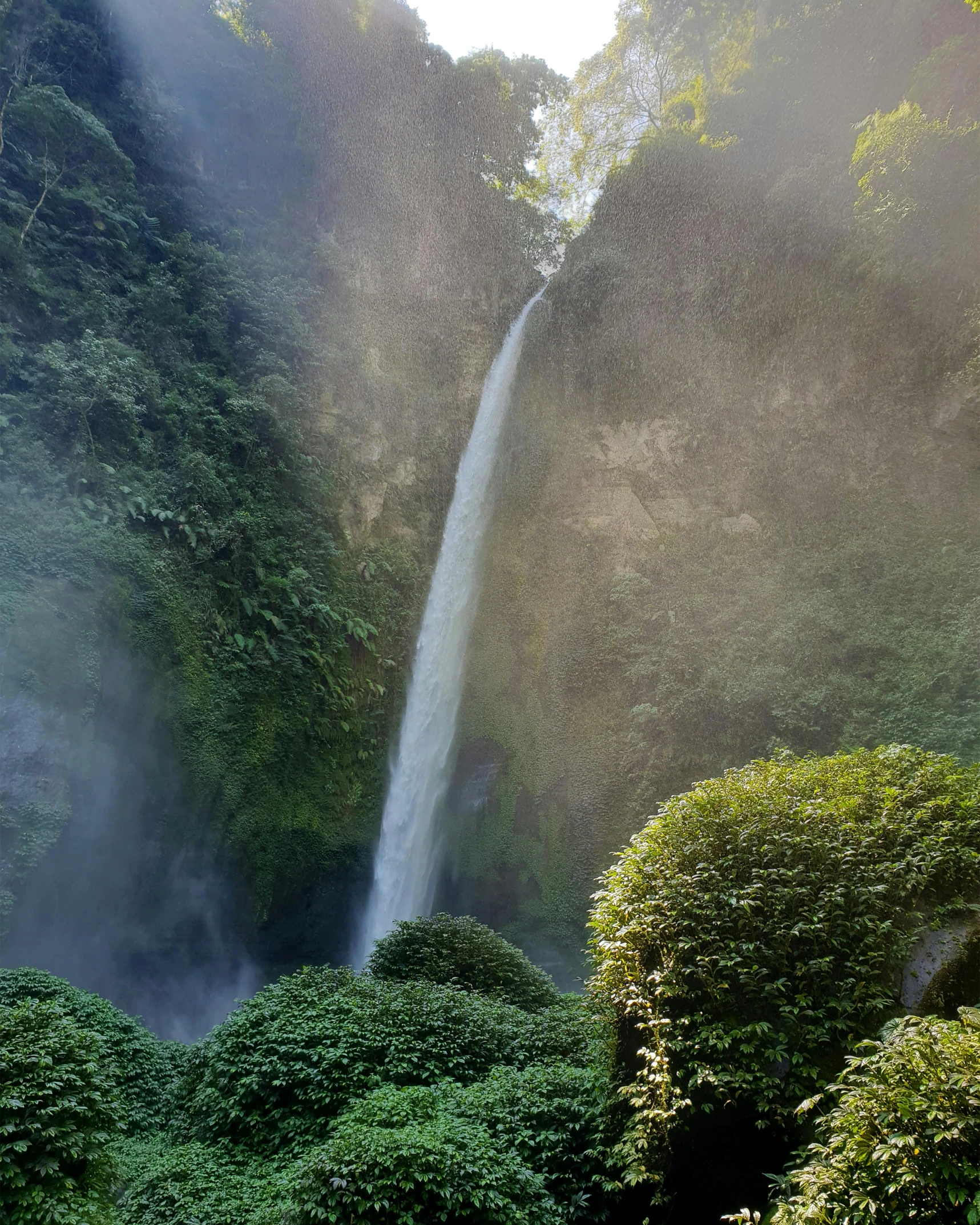 the large waterfall has a bright yellow beam coming out