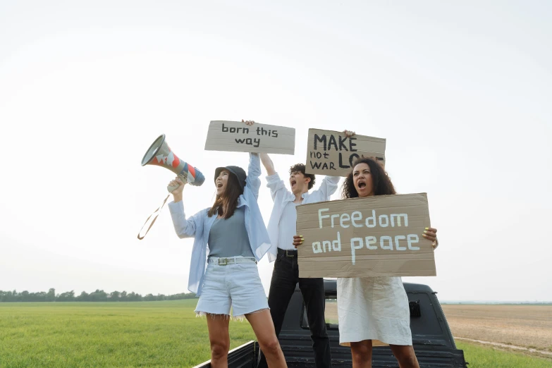 three people with a banner and a horn