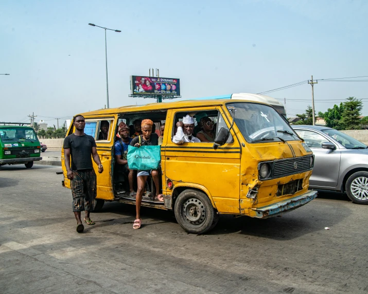 a couple of people sitting in the back of a small van