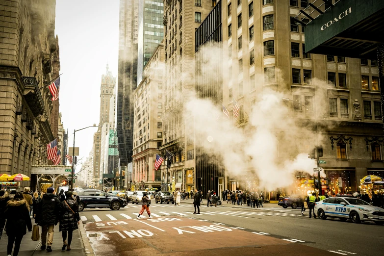 smoke and steam billows from the side of buildings on a street