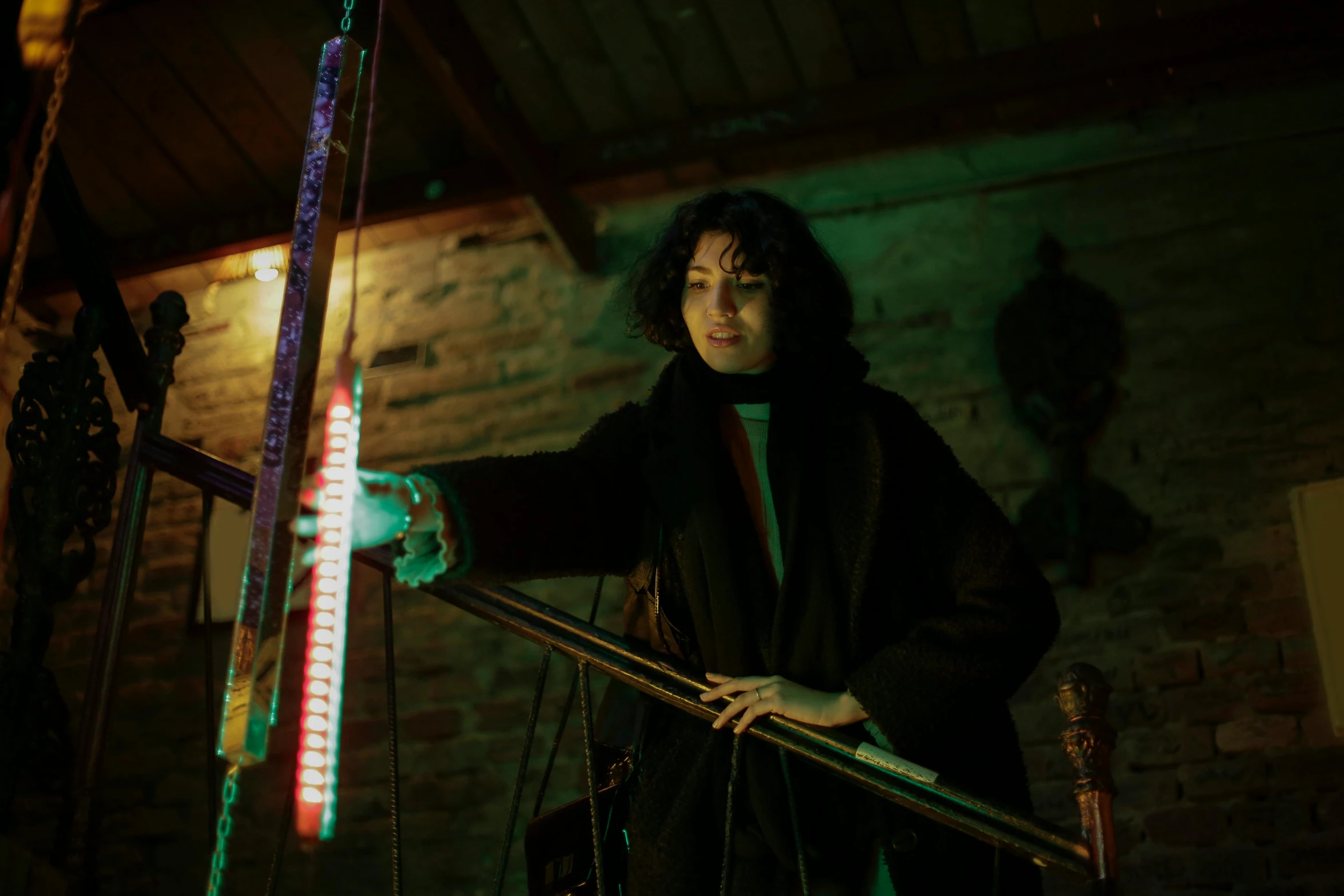 a woman is holding a handmade long - string and a light sword