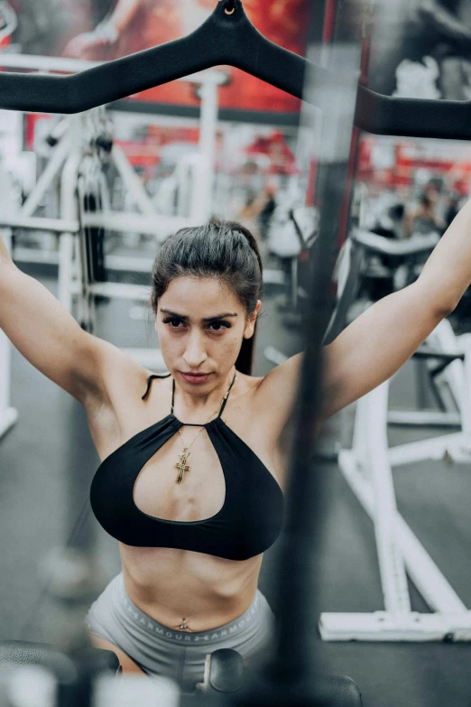 a beautiful woman is posing in a gym