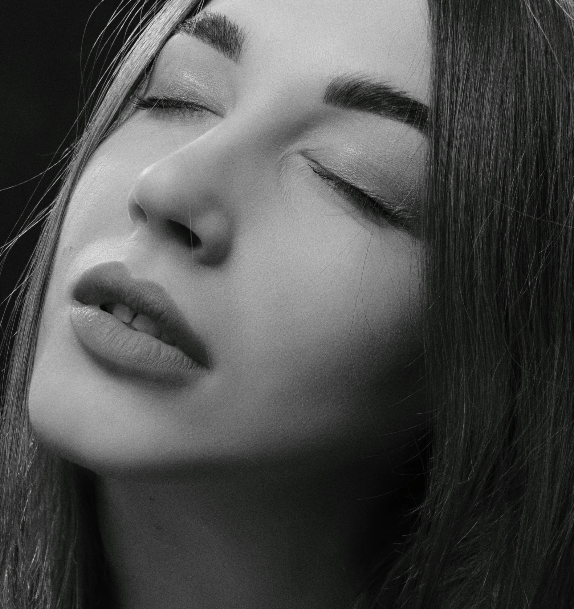 black and white pograph of woman with closed eyes