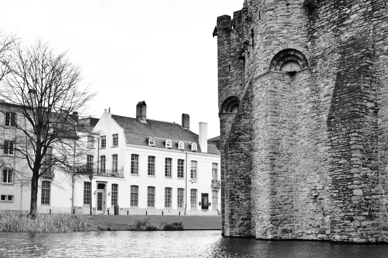 black and white po of buildings next to water