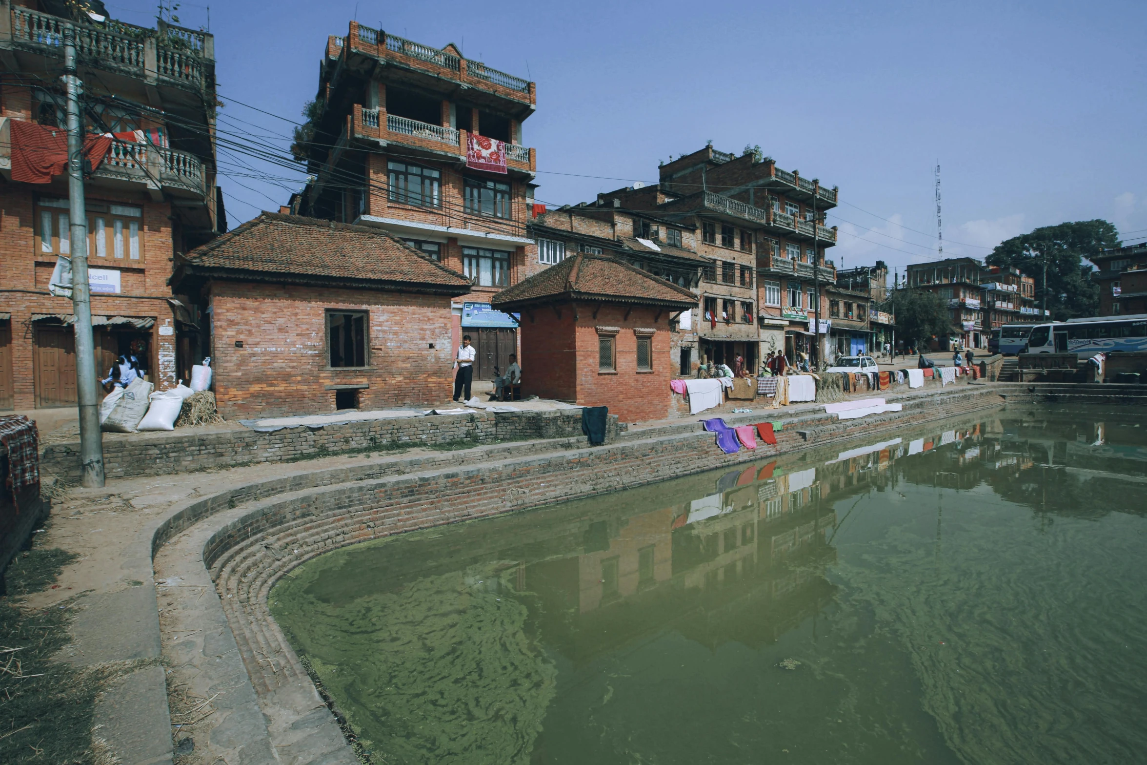 a group of people standing in the water by a building