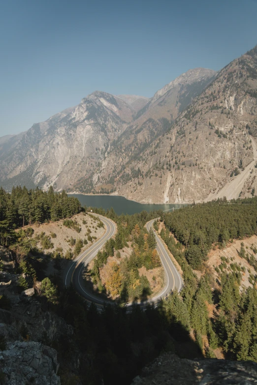 an empty mountain road is seen in this pograph