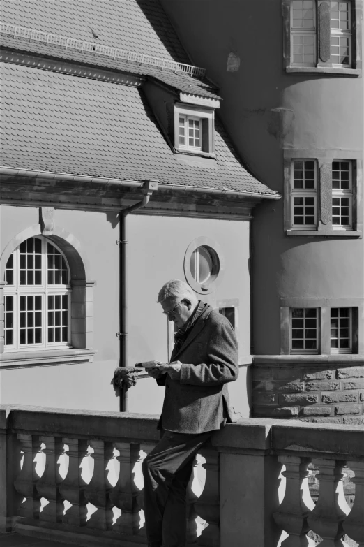 a man with a hat standing on the railing