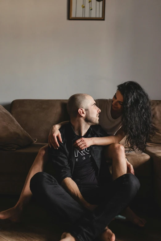 a woman sitting on top of a man's lap