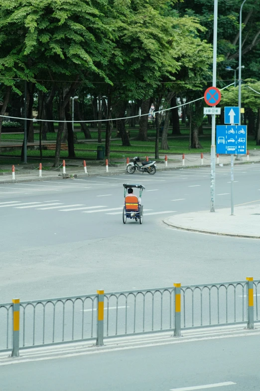 an intersection with a motorcycle riding behind it