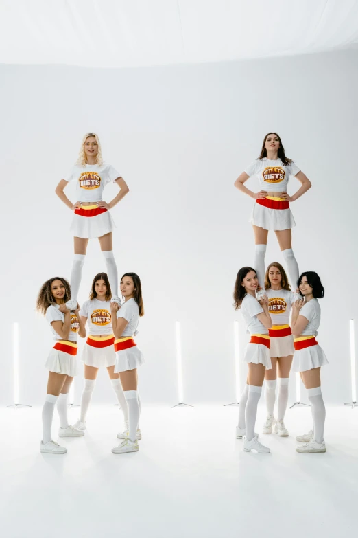 four women in cheerleader outfits with different poses