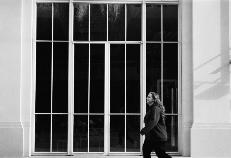 a person is walking by a window with bars in it