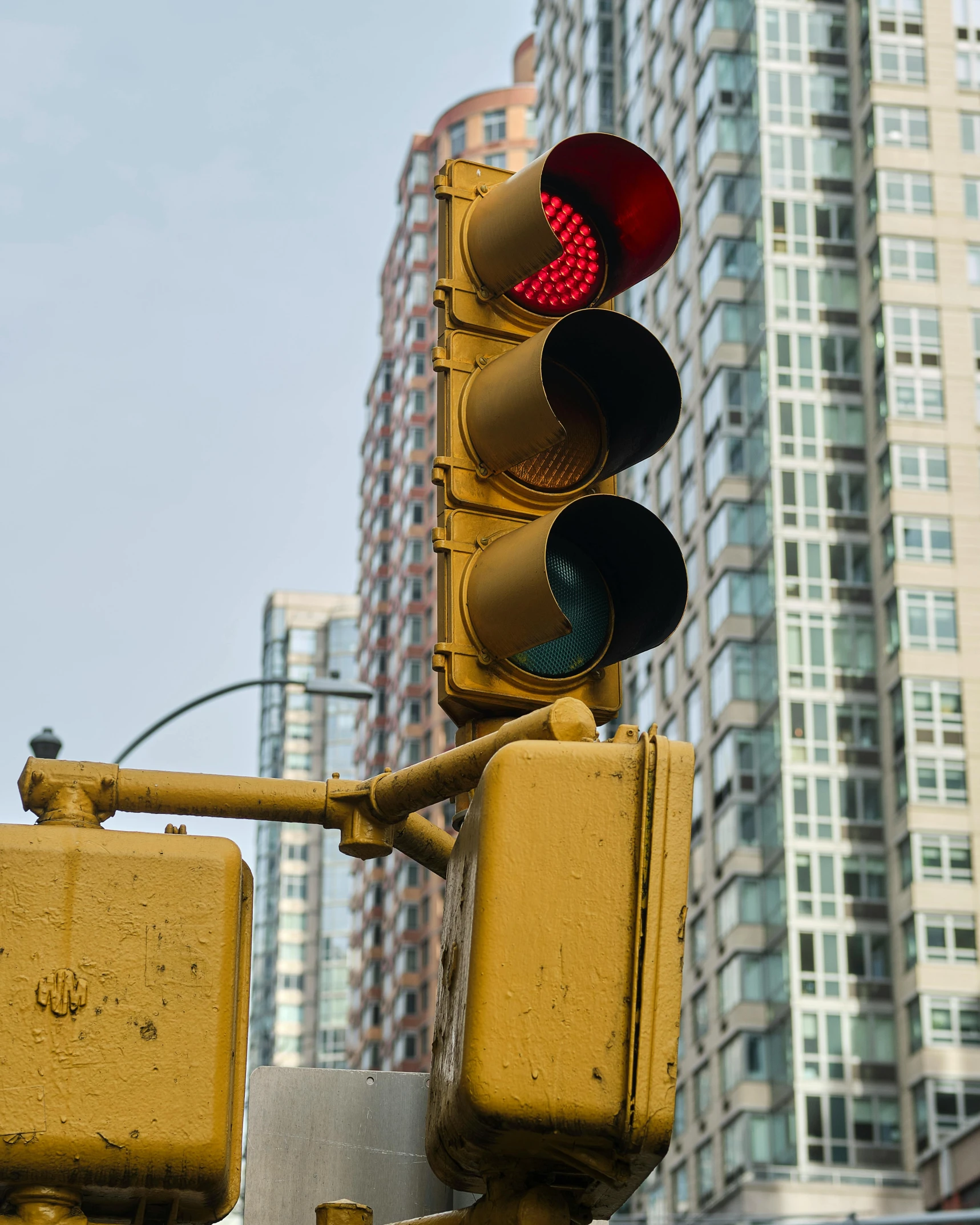 a red light with some buildings behind it