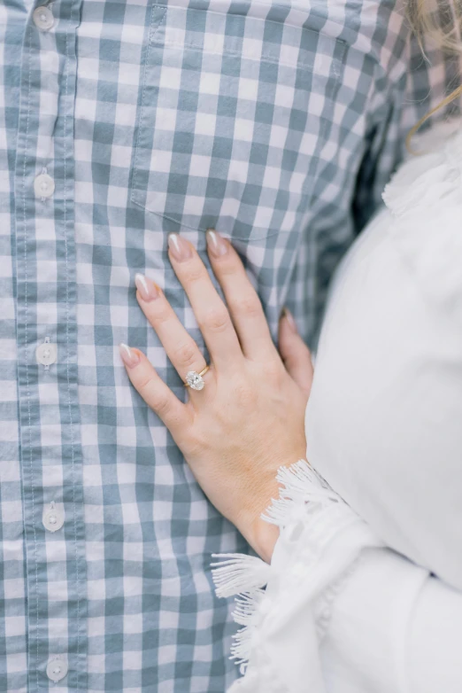 the person is holding the woman's hand