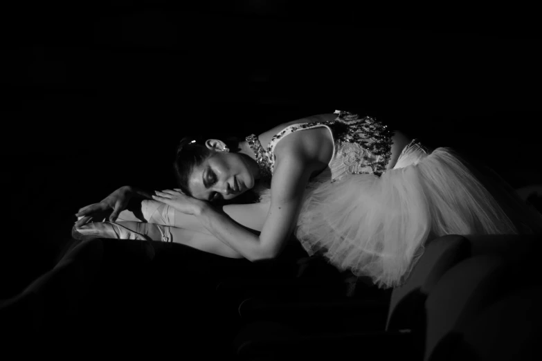 a woman is laying down in a ballerinas dress