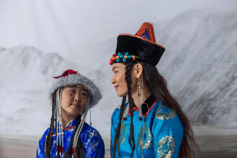 a boy and girl in native american clothing