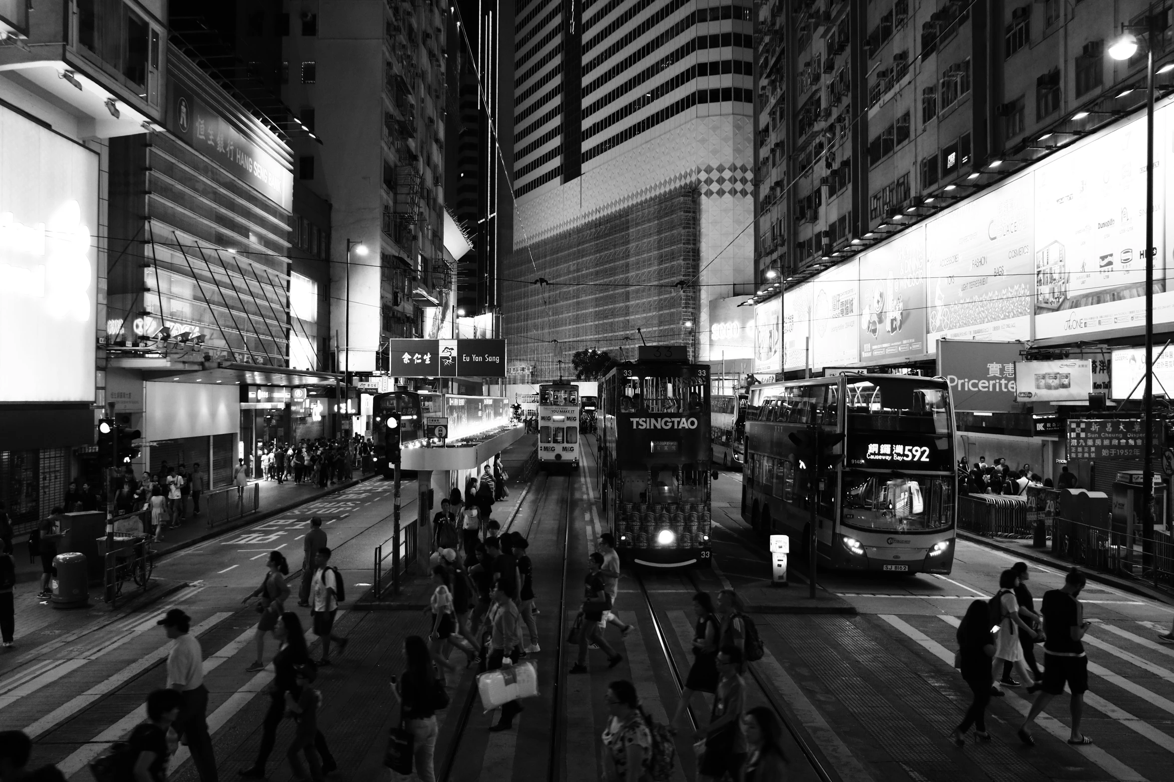 the bus has been stopped in the city and people are walking across it