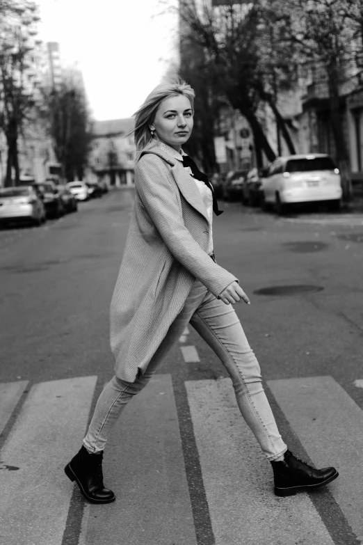 a girl crossing a crosswalk on the street