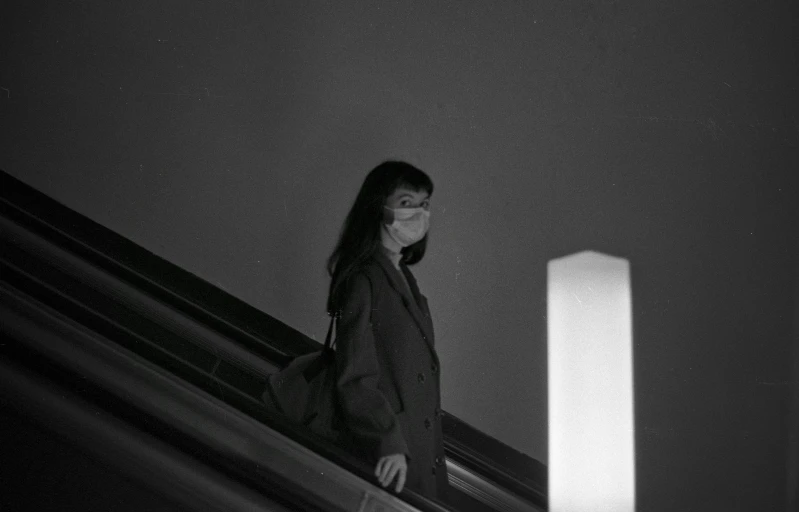 a girl walking up stairs in black and white