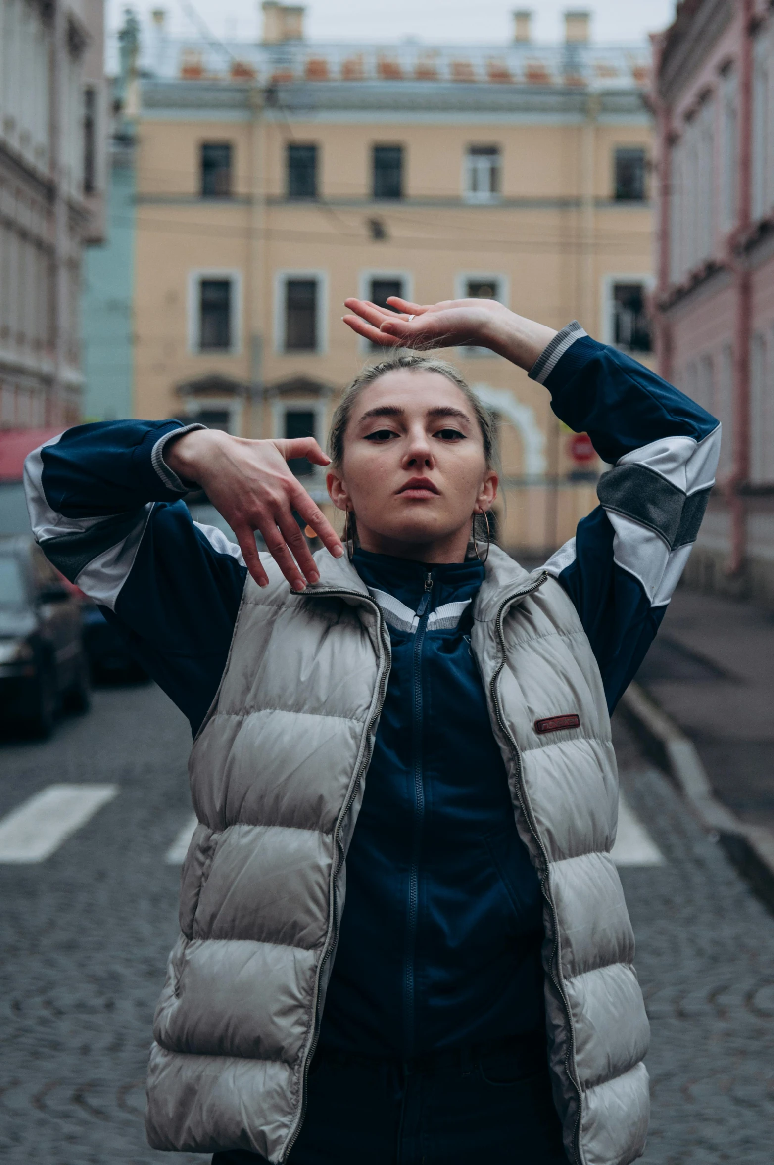 a young woman holding her hands to her hair