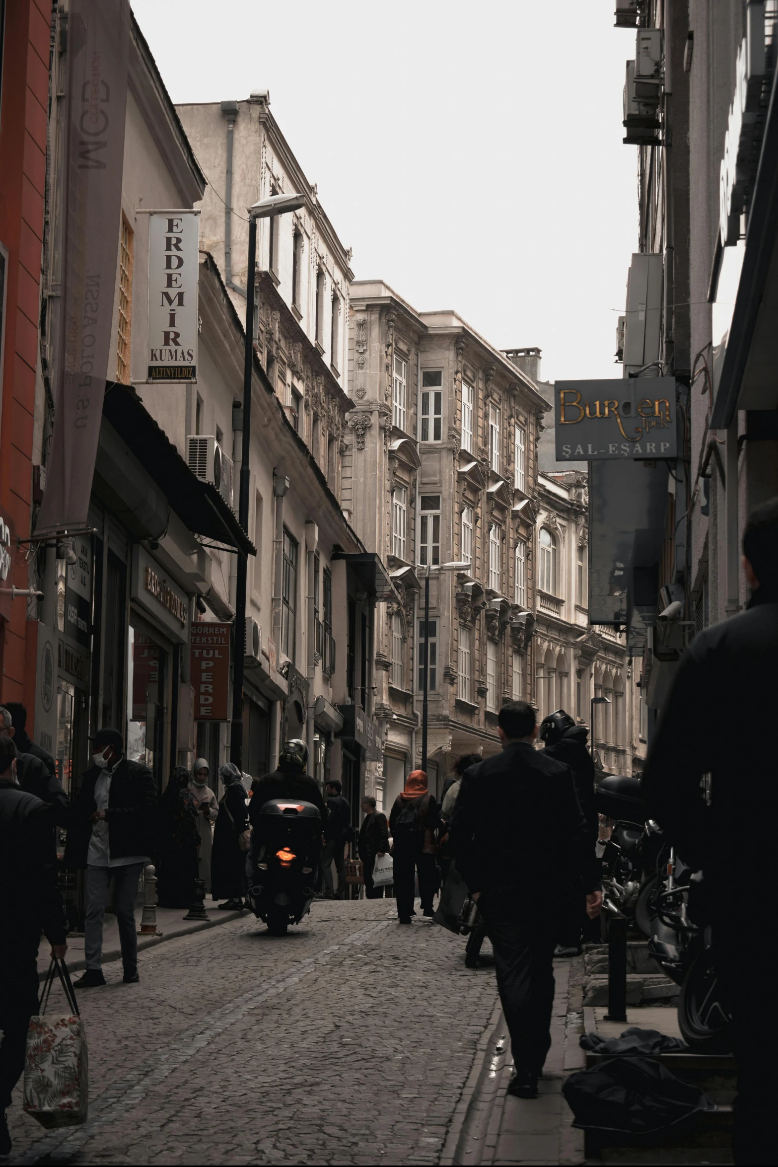 people are walking around in a shopping district